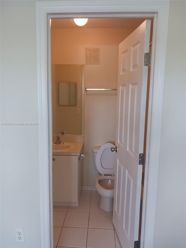 bathroom with tile patterned floors, vanity, and toilet