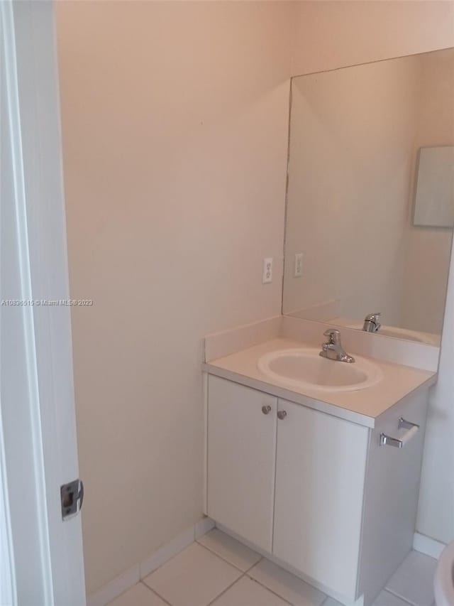 bathroom featuring tile patterned flooring and vanity