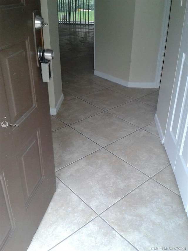 hallway with light tile patterned floors