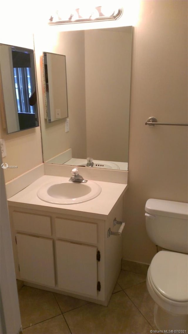 bathroom with tile patterned floors, vanity, and toilet