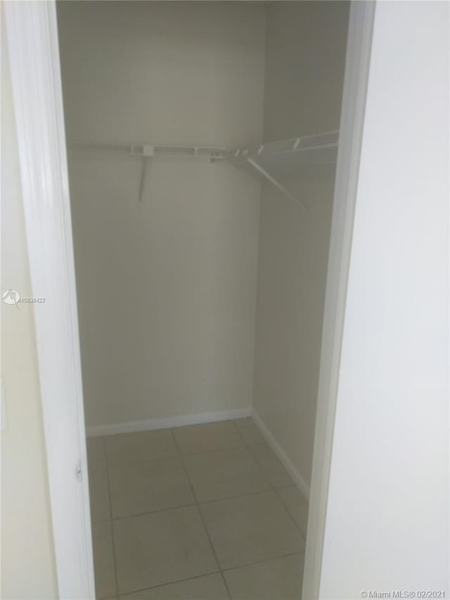 spacious closet with tile patterned floors