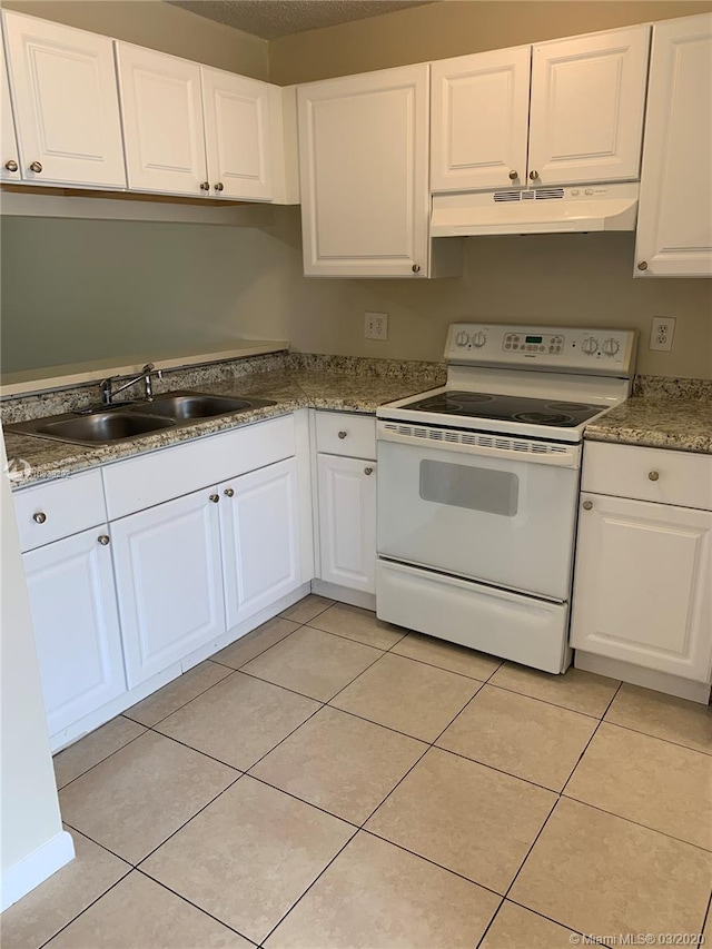 kitchen featuring white electric range oven, white cabinetry, sink, and light tile patterned floors