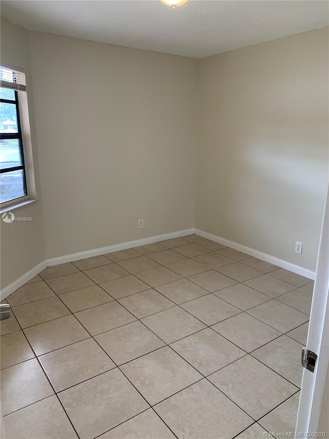 unfurnished room with light tile patterned floors