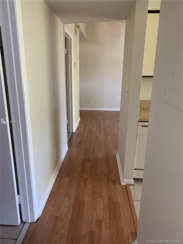 corridor featuring hardwood / wood-style floors