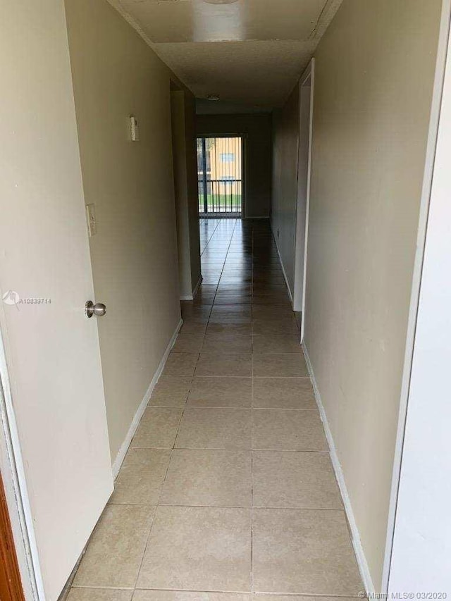 corridor with light tile patterned floors