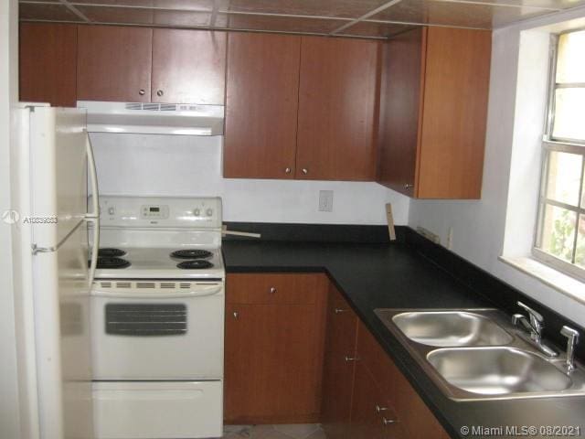 kitchen featuring sink and white appliances