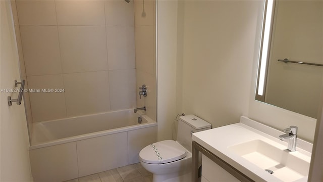 full bathroom with tile patterned floors, toilet, vanity, and tiled shower / bath