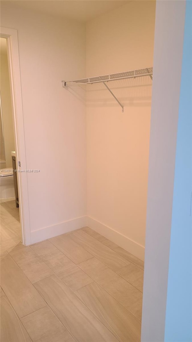 walk in closet featuring light tile patterned floors