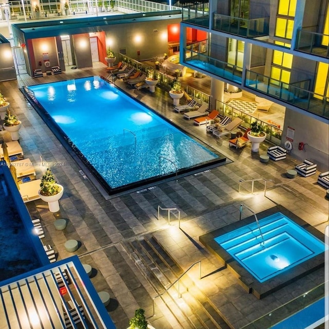 view of pool with a patio and a community hot tub