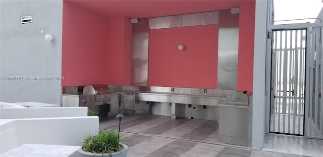 bathroom with a bathtub and tile patterned floors