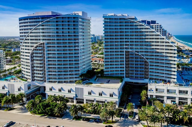 view of building exterior featuring a water view and a city view