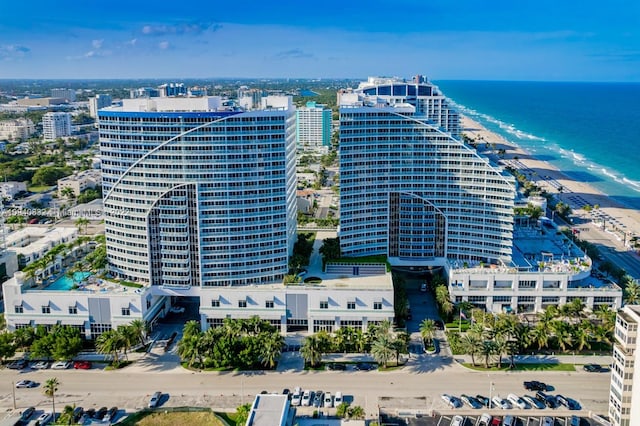 aerial view featuring a view of the beach, a water view, and a city view