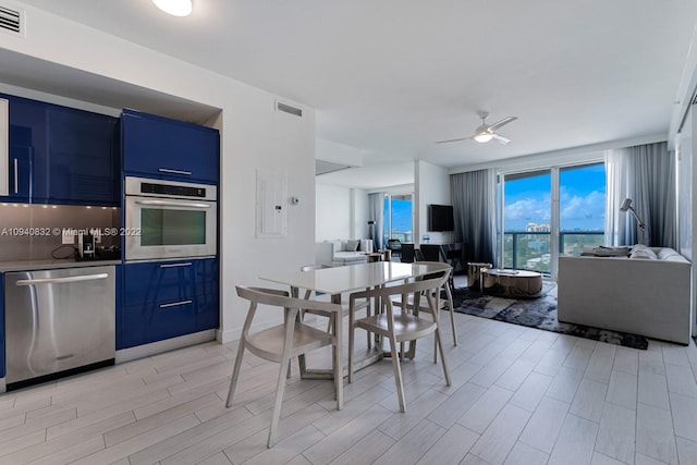 dining space with light wood-type flooring and ceiling fan