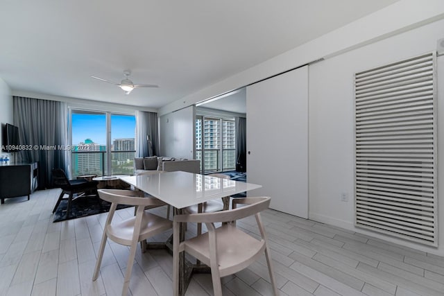 dining space with ceiling fan and light hardwood / wood-style floors