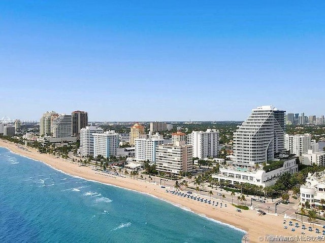 bird's eye view with a water view and a beach view