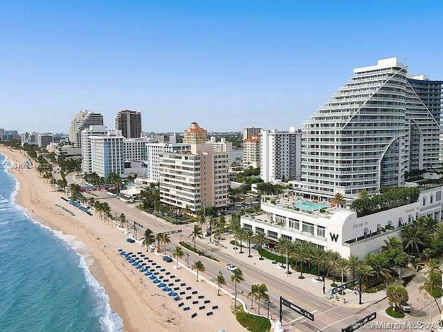 bird's eye view with a water view and a beach view