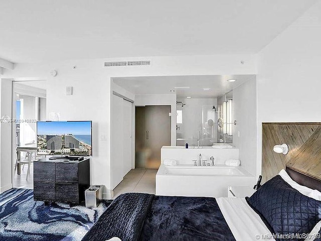 bedroom featuring light tile patterned flooring