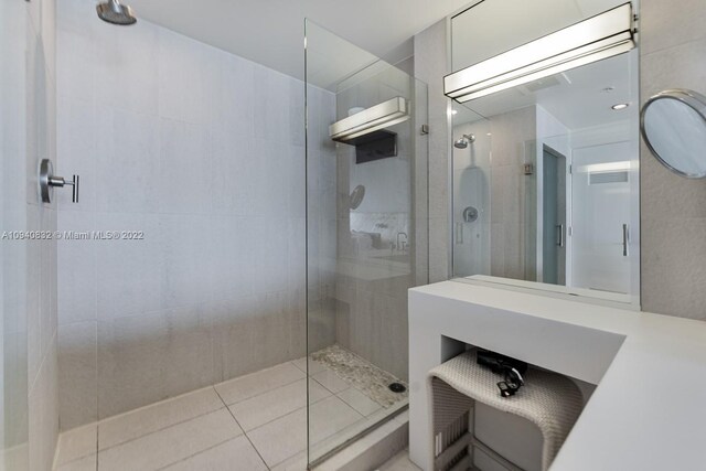 bathroom with a shower with shower door