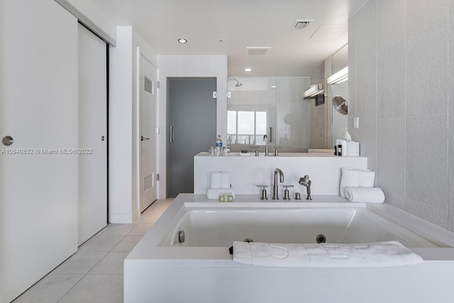 bathroom featuring tile patterned flooring, visible vents, a jetted tub, and tiled shower