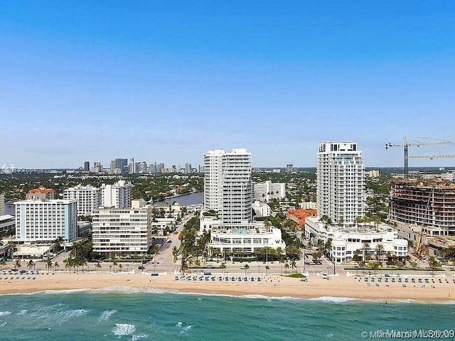 birds eye view of property with a city view, a beach view, and a water view