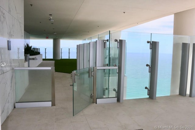 bathroom with a water view and tile flooring