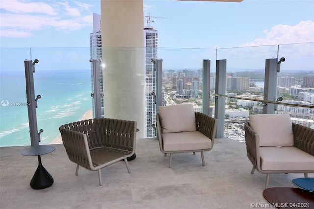 view of patio with a balcony and a water view