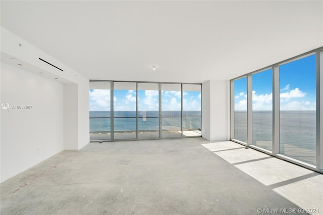 empty room with floor to ceiling windows and a water view