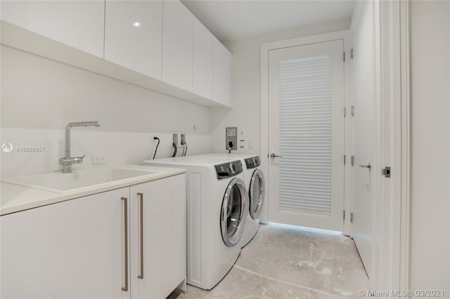 washroom with washer hookup, hookup for an electric dryer, independent washer and dryer, sink, and cabinets