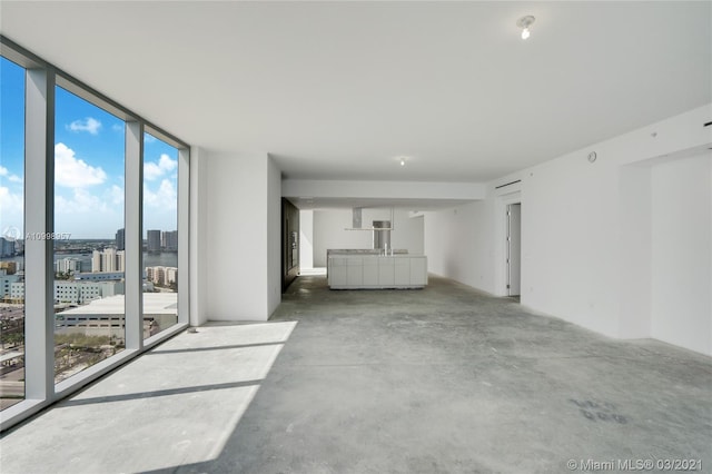 unfurnished living room with expansive windows