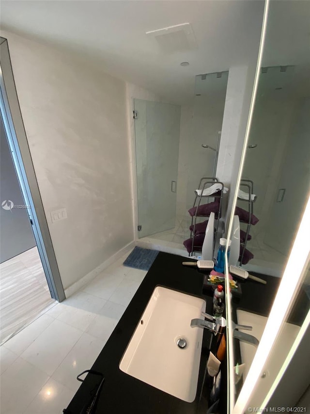 bathroom with tile floors and sink