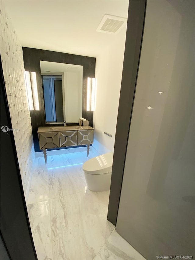 bathroom with toilet and tile floors