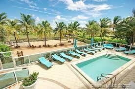 view of pool with a hot tub