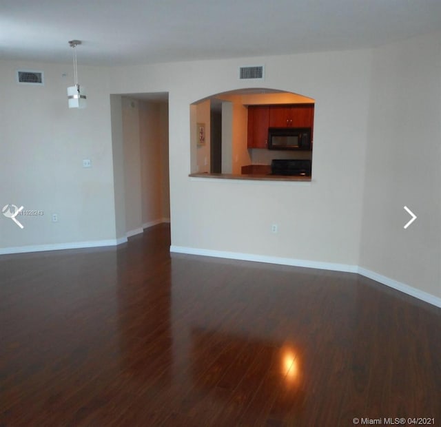 unfurnished room featuring dark wood-type flooring