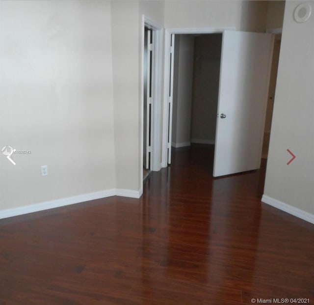 empty room featuring dark wood-type flooring