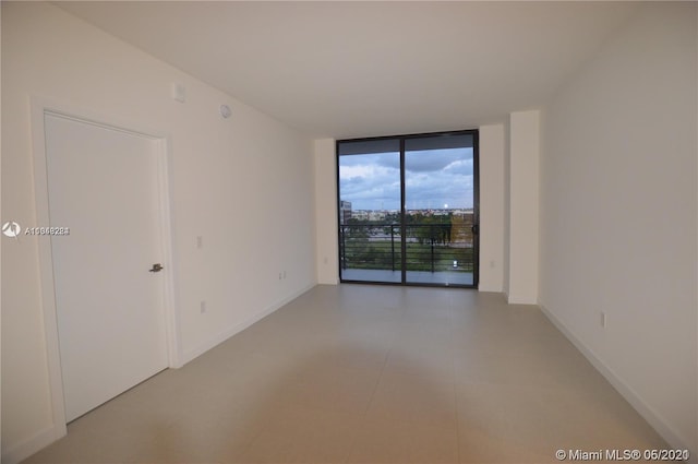 tiled spare room with expansive windows