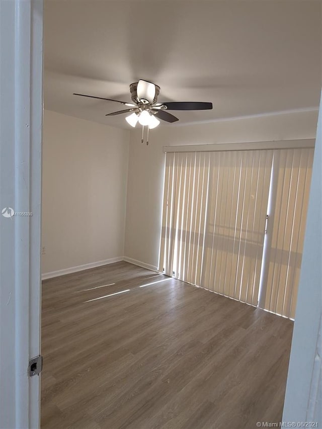 unfurnished room featuring ceiling fan and wood-type flooring