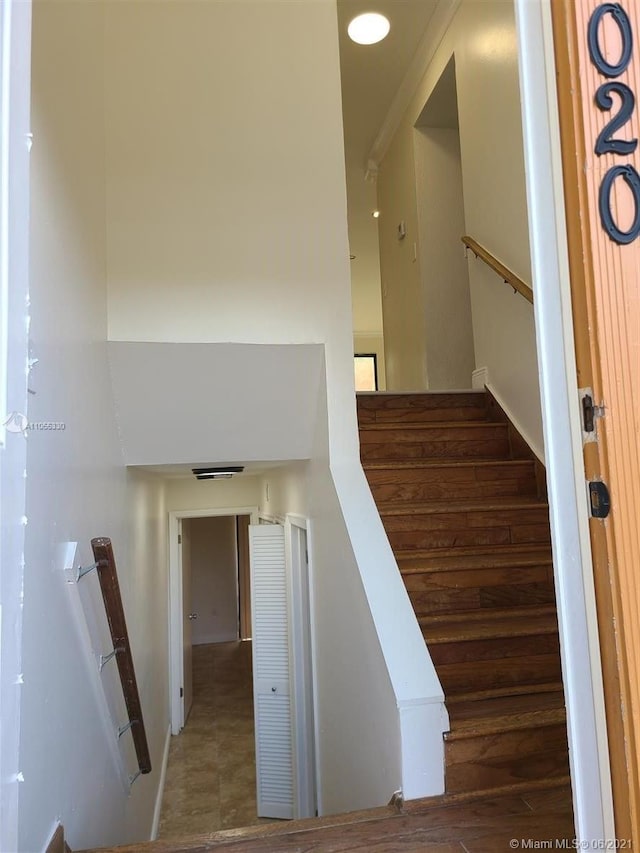 staircase with hardwood / wood-style floors