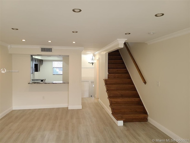 interior space with hardwood / wood-style floors and ornamental molding