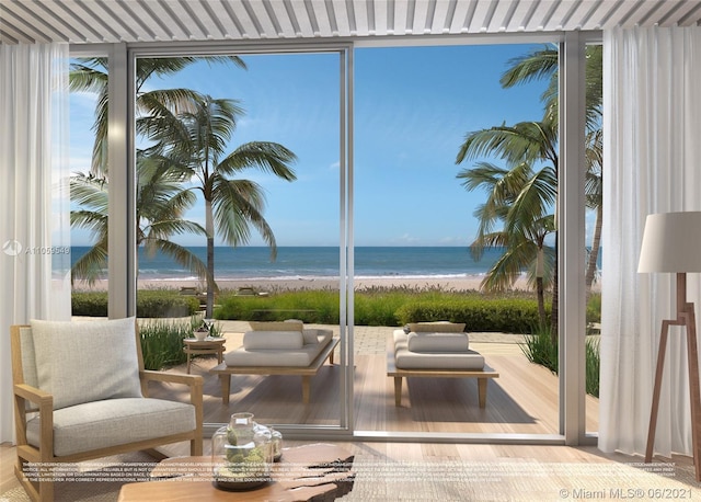 exterior space featuring an outdoor hangout area, a water view, and a view of the beach