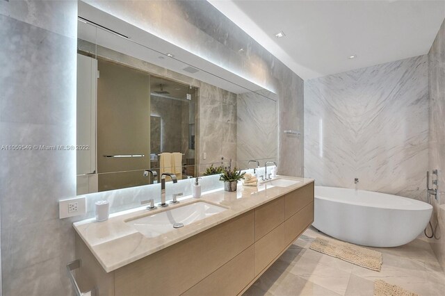 bathroom with tile walls, vanity, and plus walk in shower