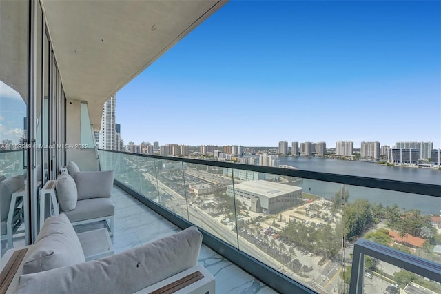 balcony featuring a water view and outdoor lounge area