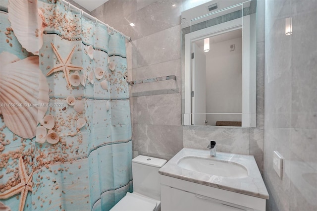 bathroom featuring vanity, curtained shower, backsplash, tile walls, and toilet