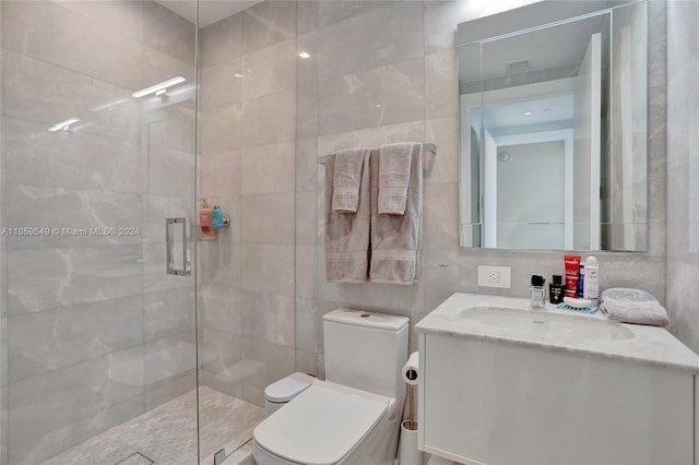 bathroom with tile walls, backsplash, vanity, toilet, and an enclosed shower