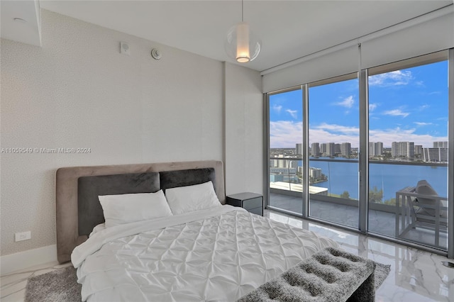 bedroom with a water view and access to exterior