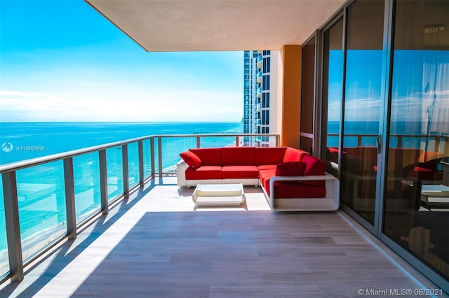 balcony featuring a water view and outdoor lounge area