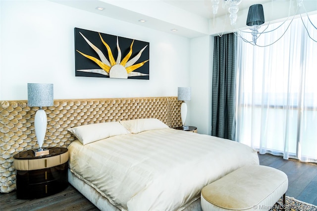 bedroom featuring a chandelier and dark hardwood / wood-style flooring