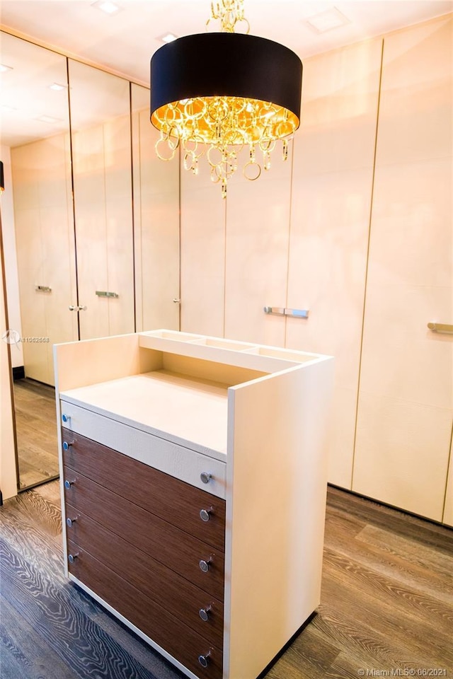 bathroom featuring a notable chandelier, vanity, and hardwood / wood-style floors