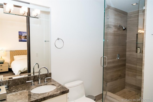 bathroom with vanity, hardwood / wood-style floors, toilet, and a shower with door