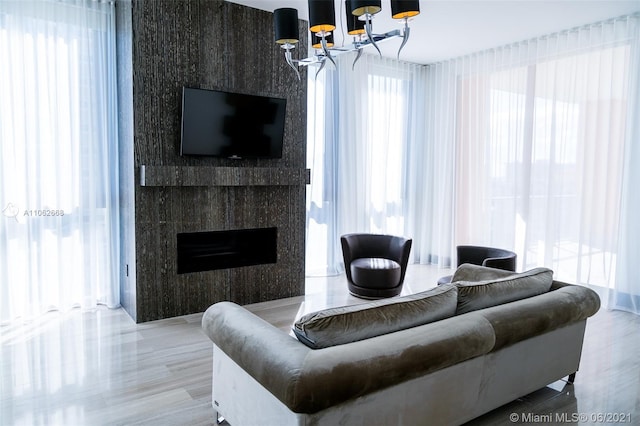 living room featuring an inviting chandelier and wood-type flooring