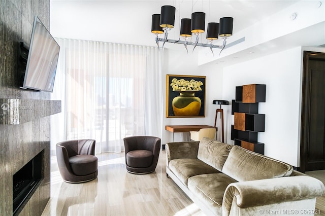 living room with hardwood / wood-style flooring and a chandelier